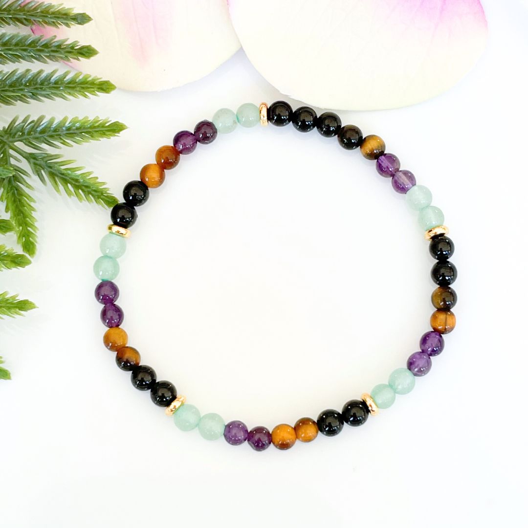 4mm wealth and prosperity bracelet made with black tourmaline, tigers eye, amethyst, and green aventurine with gold accents
