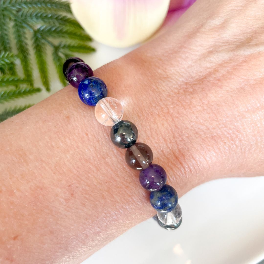 Multicolored beaded bracelet on a wrist with a blurred background