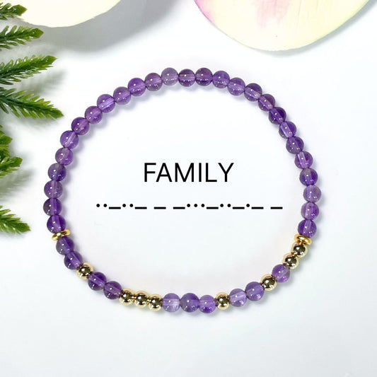 Purple beaded morse code bracelet with gold accents on a white background, labeled 'FAMILY'.