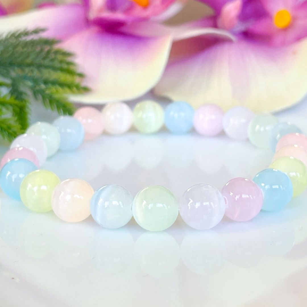 Pastel-colored beaded bracelet on a soft background with flowers