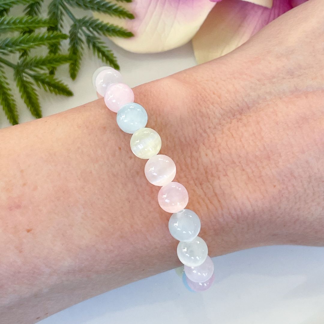 Multicolored beaded bracelet on a wrist with a soft focus background